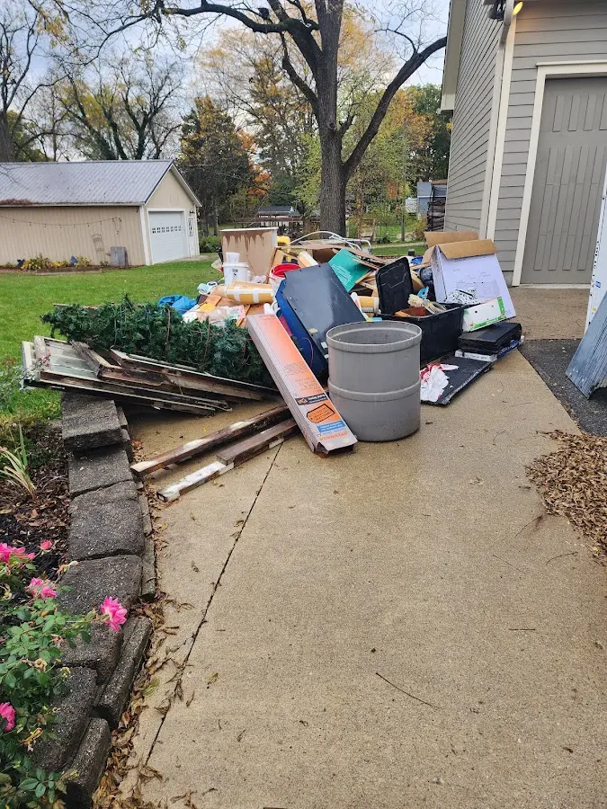 Dumpster being loaded with debris for Residential Dumpster Rental in Luling